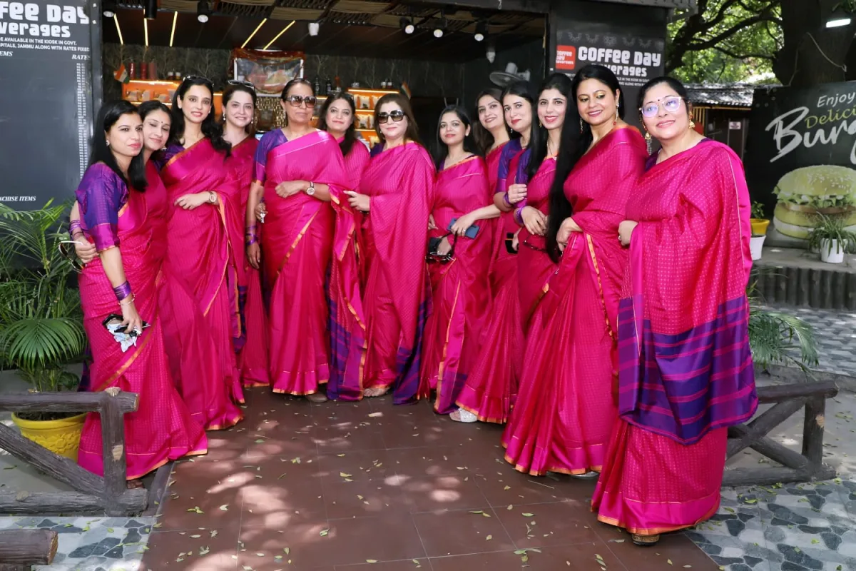 The organising team in coordinated pink sarees, together ahead of the conference.